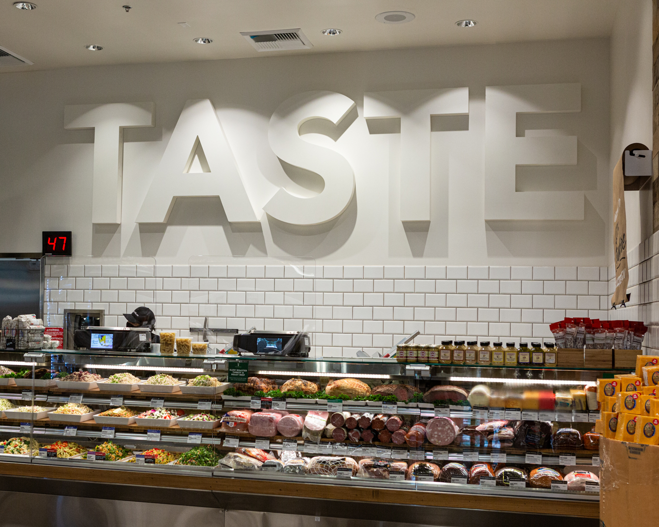 Bristol Farms Product aisle with employee standing infront