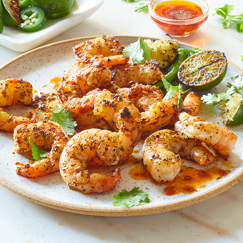 shrimp served on a plate with lime
