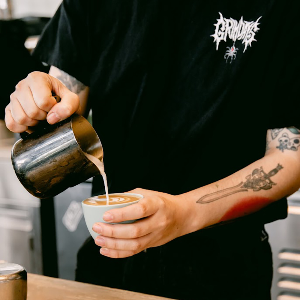 man pouring coffee roaster