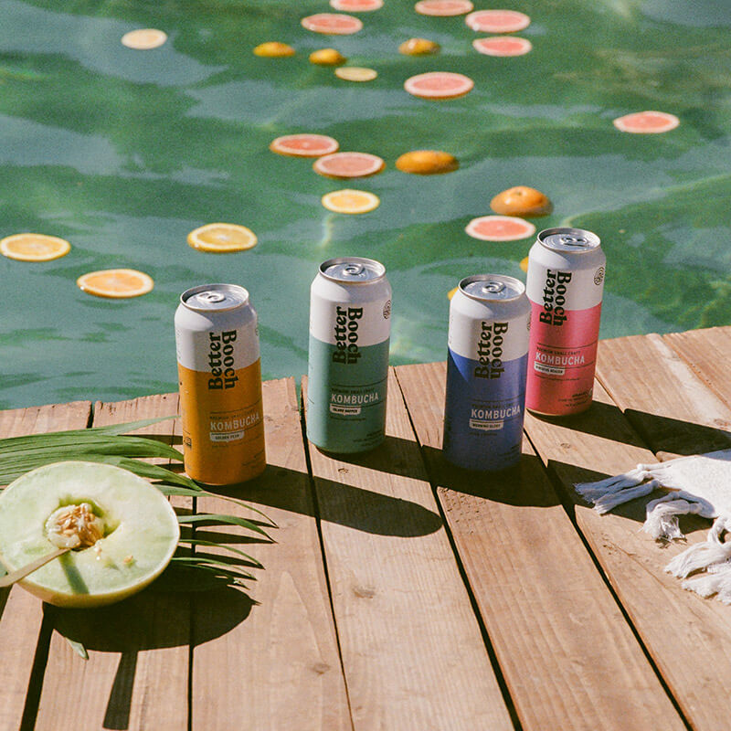 cans of Better Booch by a pool