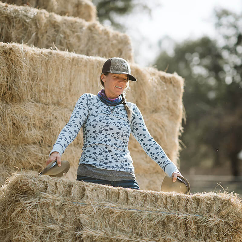 Carrie Richards with bales of hay