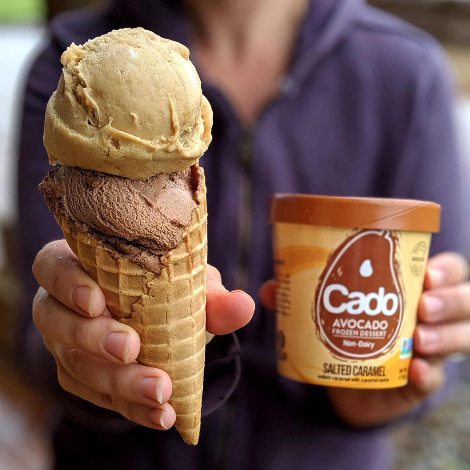 person holding cone with cado in it