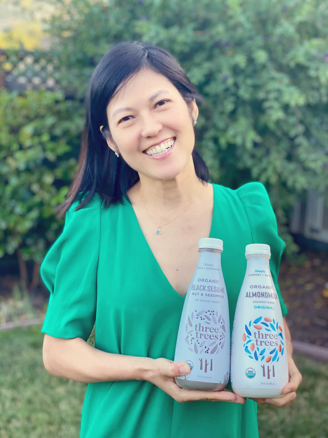 Founder Jenny Eu holding two bottles of milk