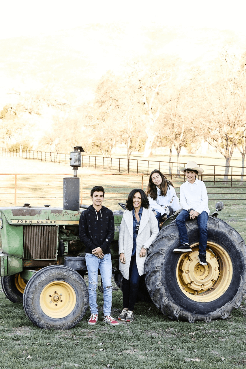 Angela and her family sitting on a tractor