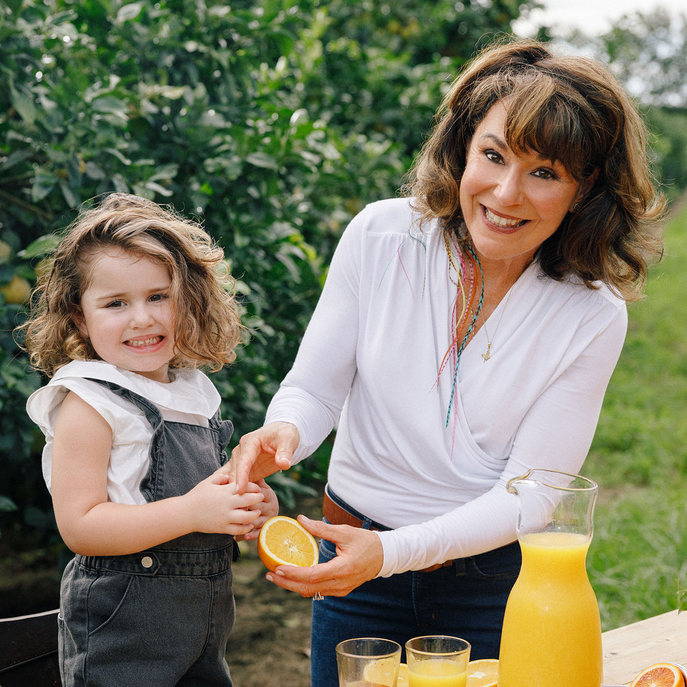 Marygrace with her child making orange juice