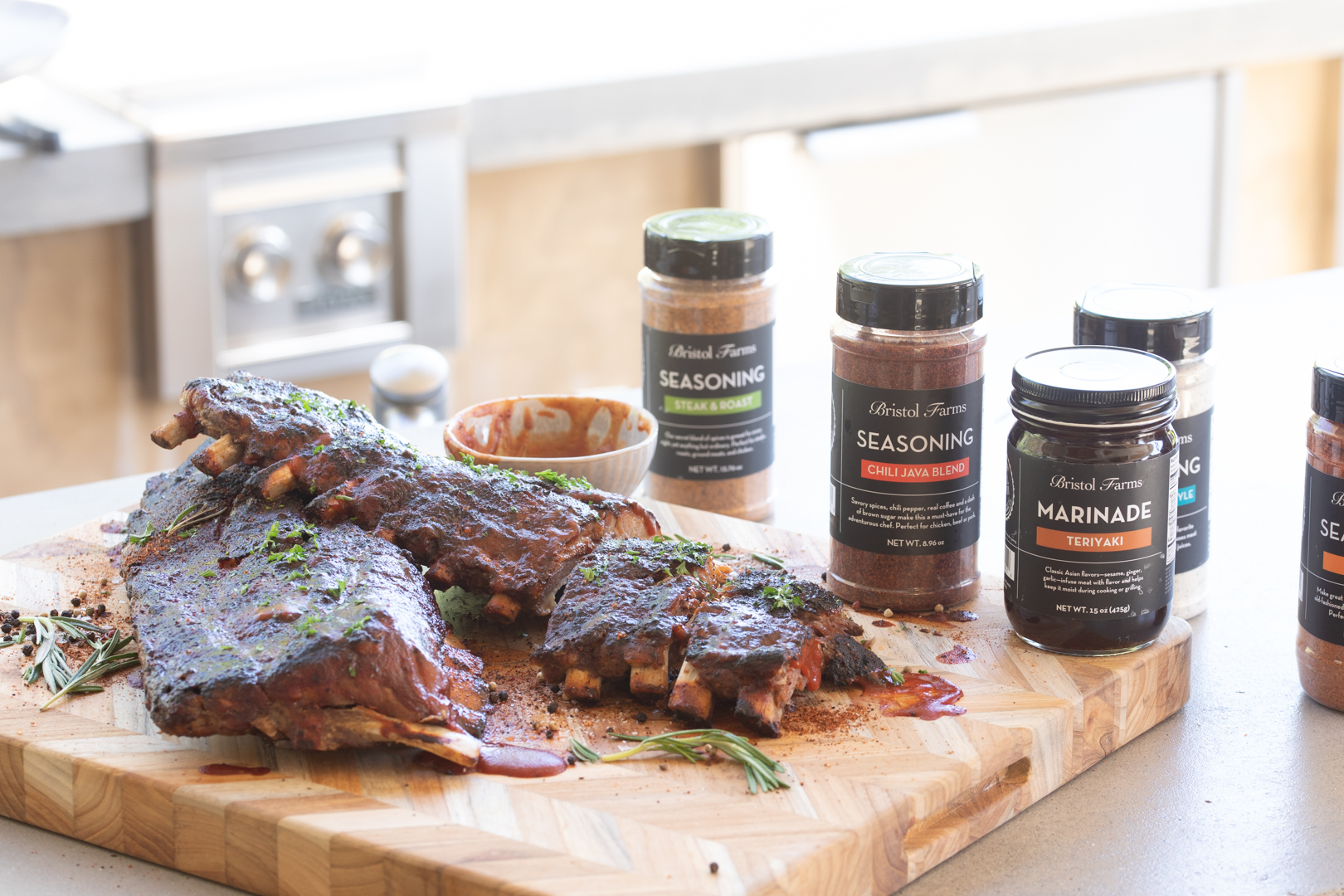 Ribs on a butcher block with marinades and seasonings