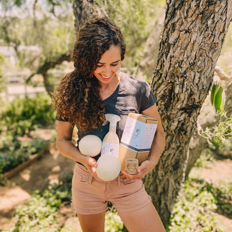 Kristin holding Root & Splendor products