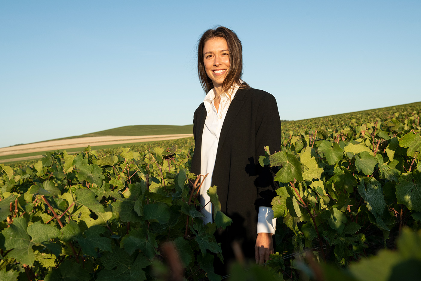 Lucie in a field of grapes