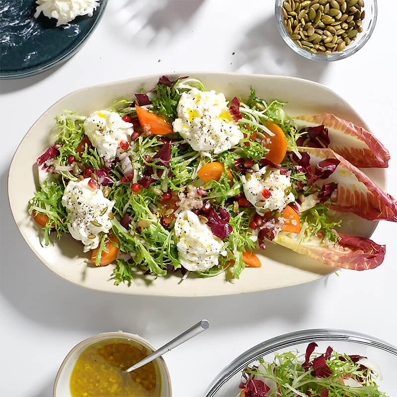 Winter Greens Salad With Persimmon, Burrata, And Honey Shallot Dressing