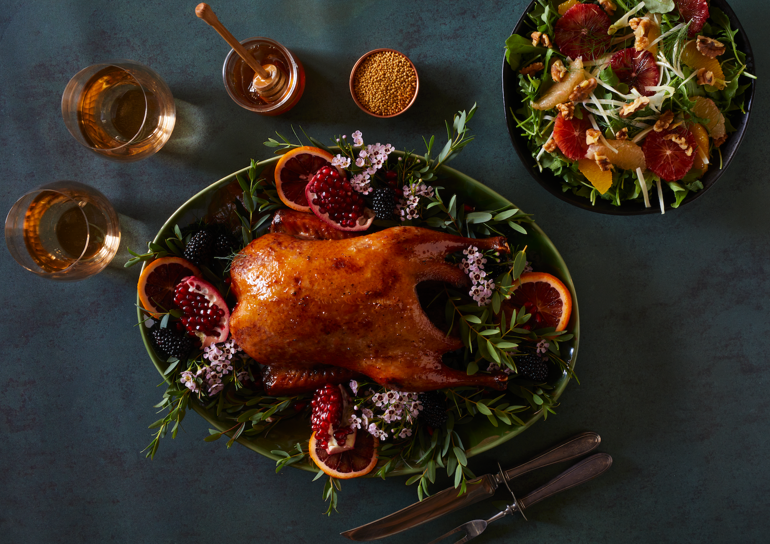 roasted duck on counter with wine and salad
