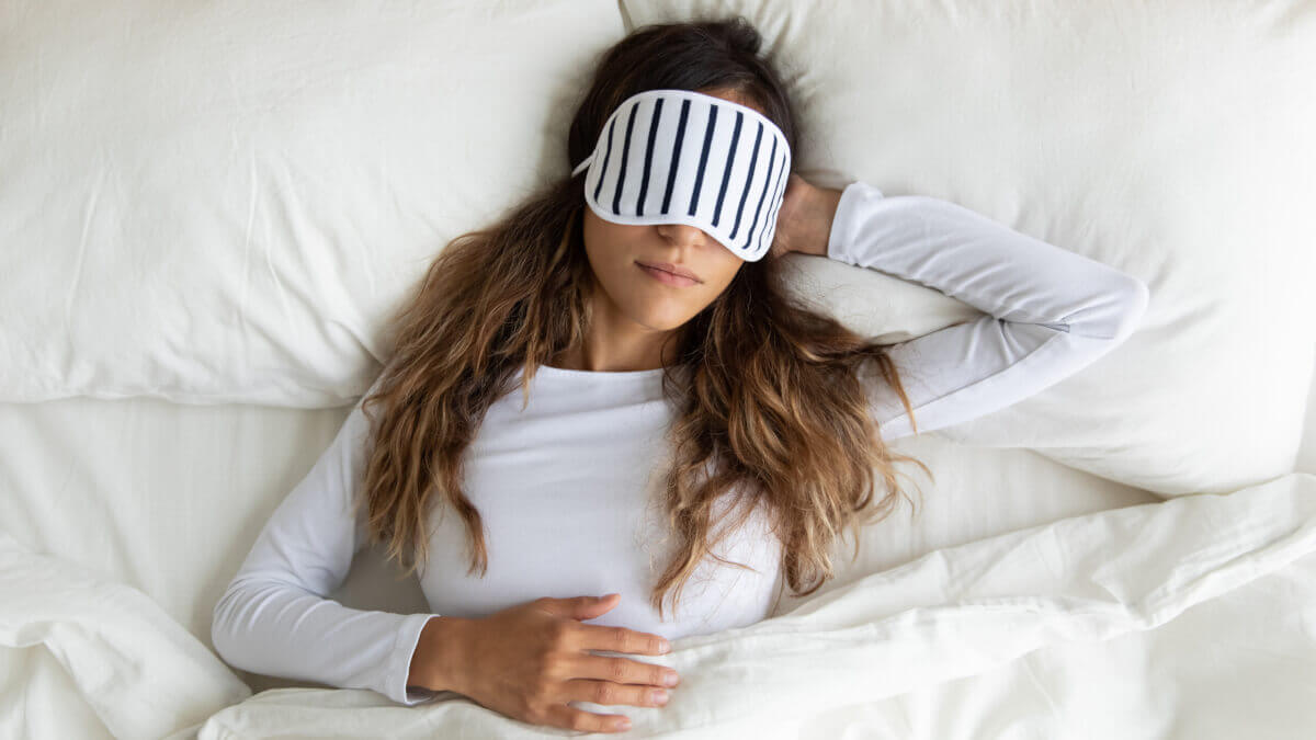 woman sleeping with an eye mask 