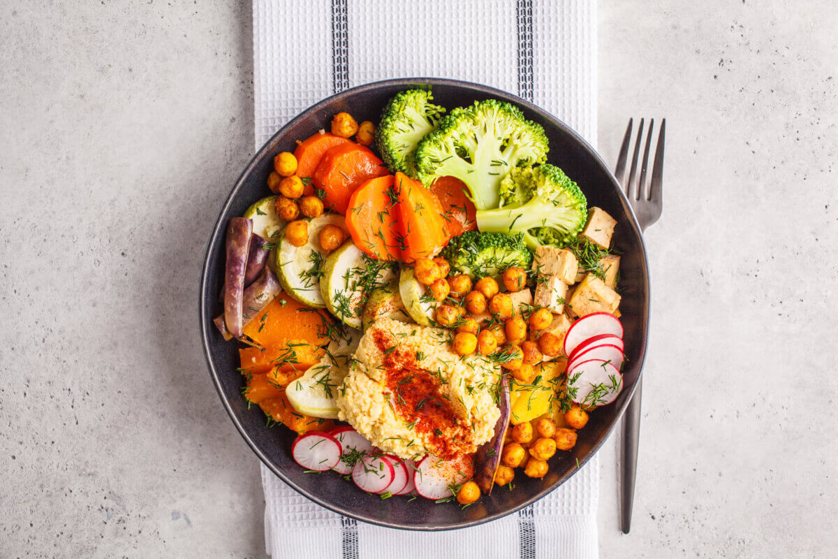 bowl with vegetables and hummus 
