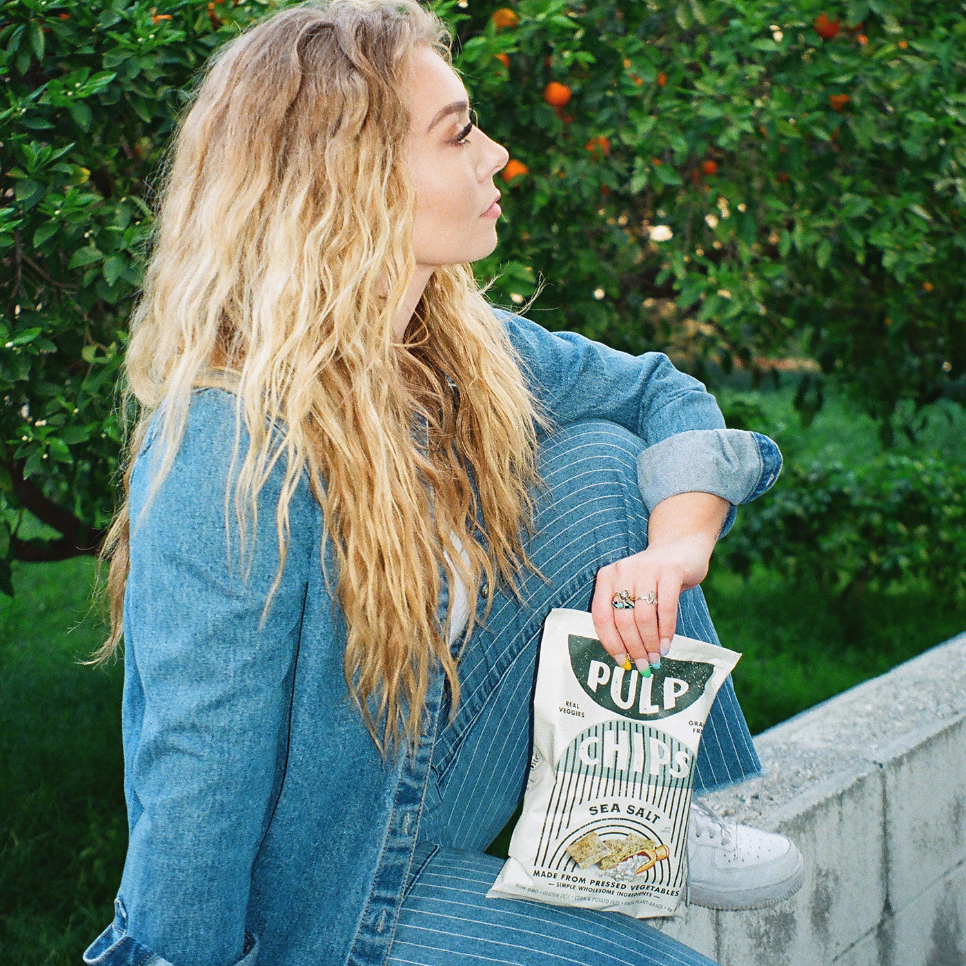 Girl holding bag of Pulp Chips