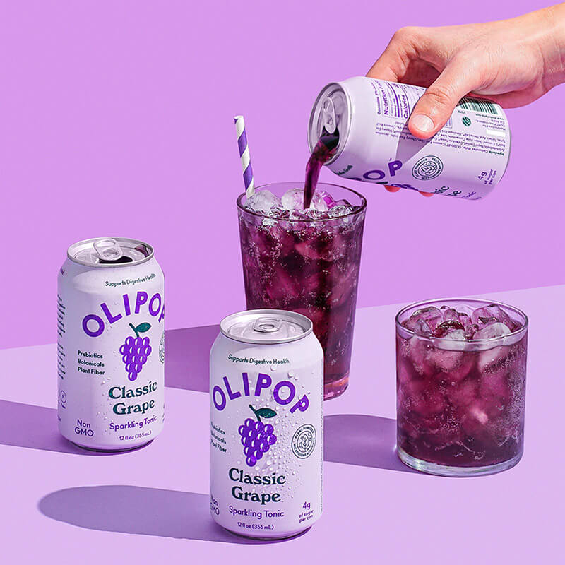 Two cups and cans of Olipop 