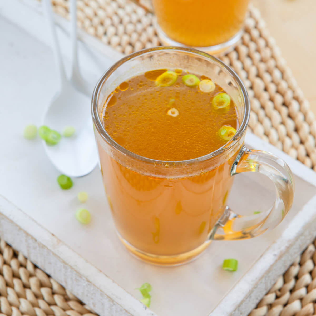 mug of broth with scallions