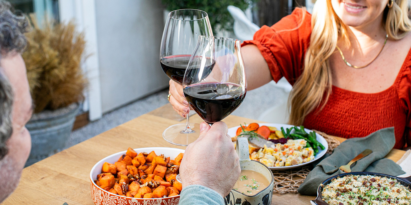 gorgeous woman toasting with man at dinner table