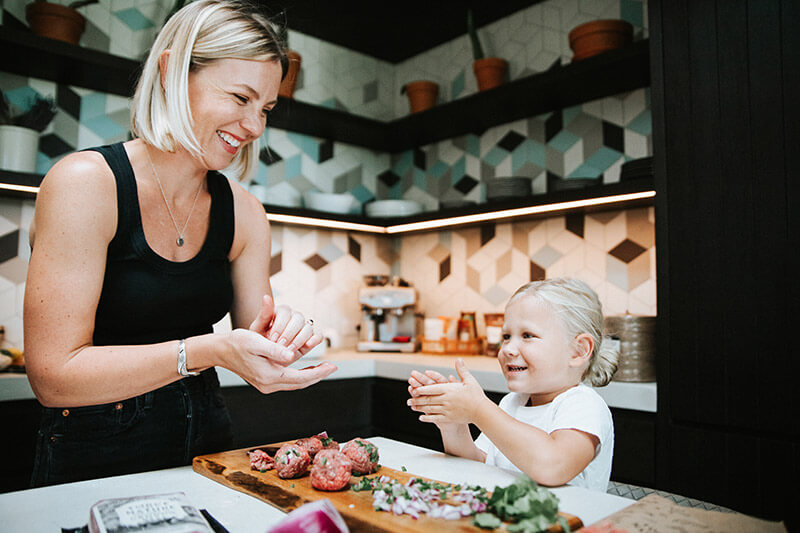 Woman and her child making meatballs