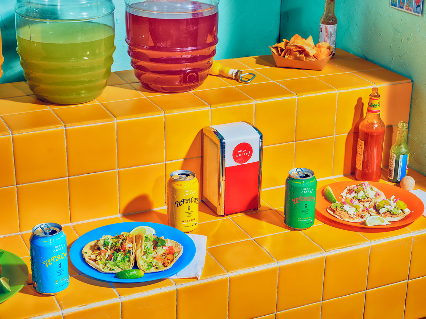 Colorful spread of tacos and beverages