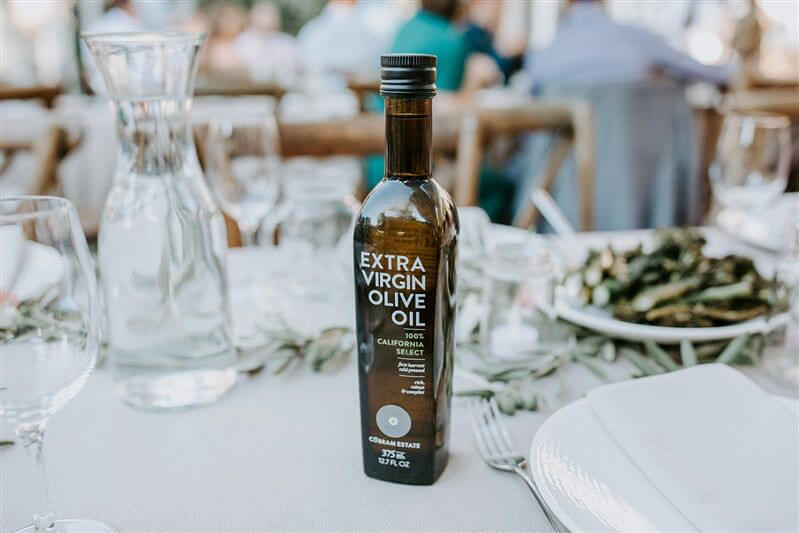 Bottle of extra virgin olive oil on a dinner table