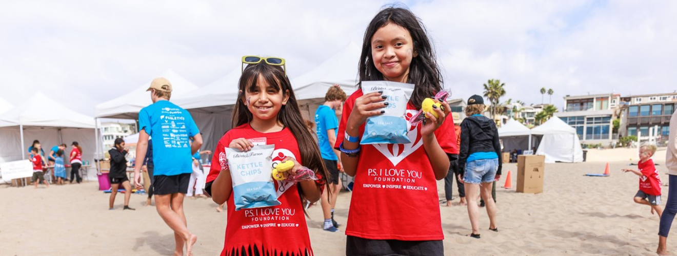 Kids at community event holding potato chips