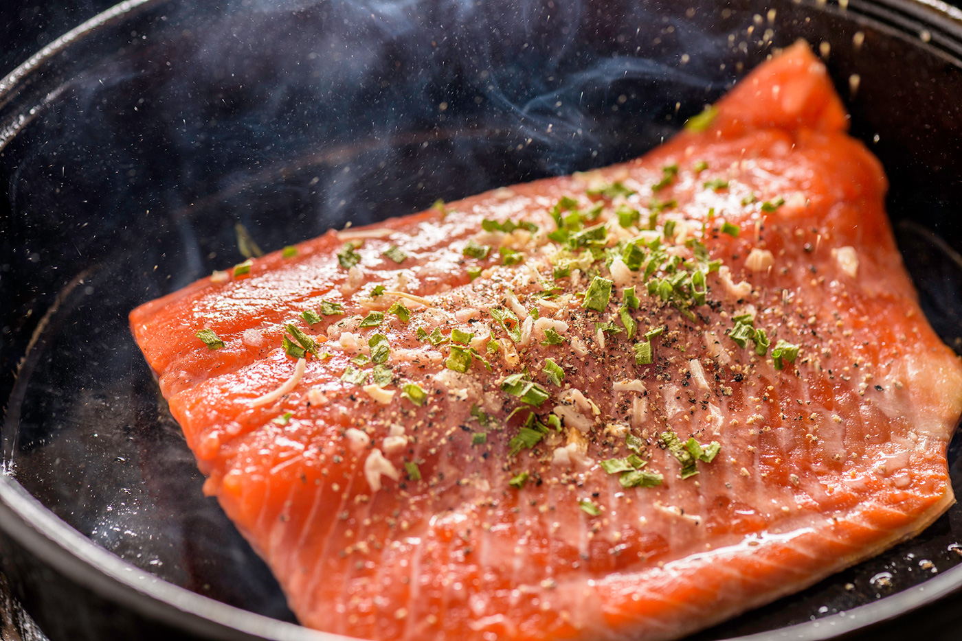 filet of salmon cooking in skillet