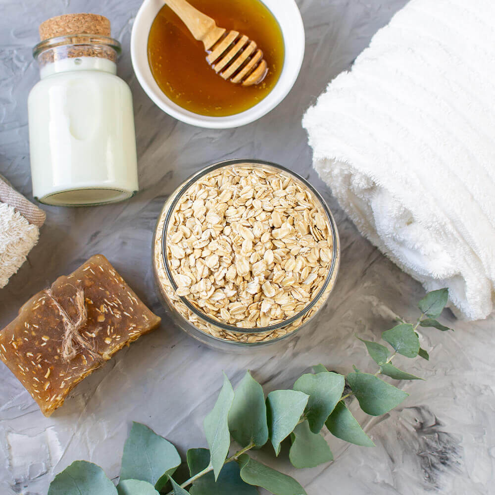 bowl of oatmeal, milk, honey and bar of soap