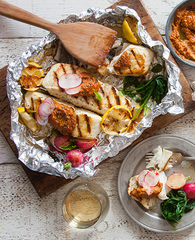 grilled halibut in foil with lemon and radish garnish
