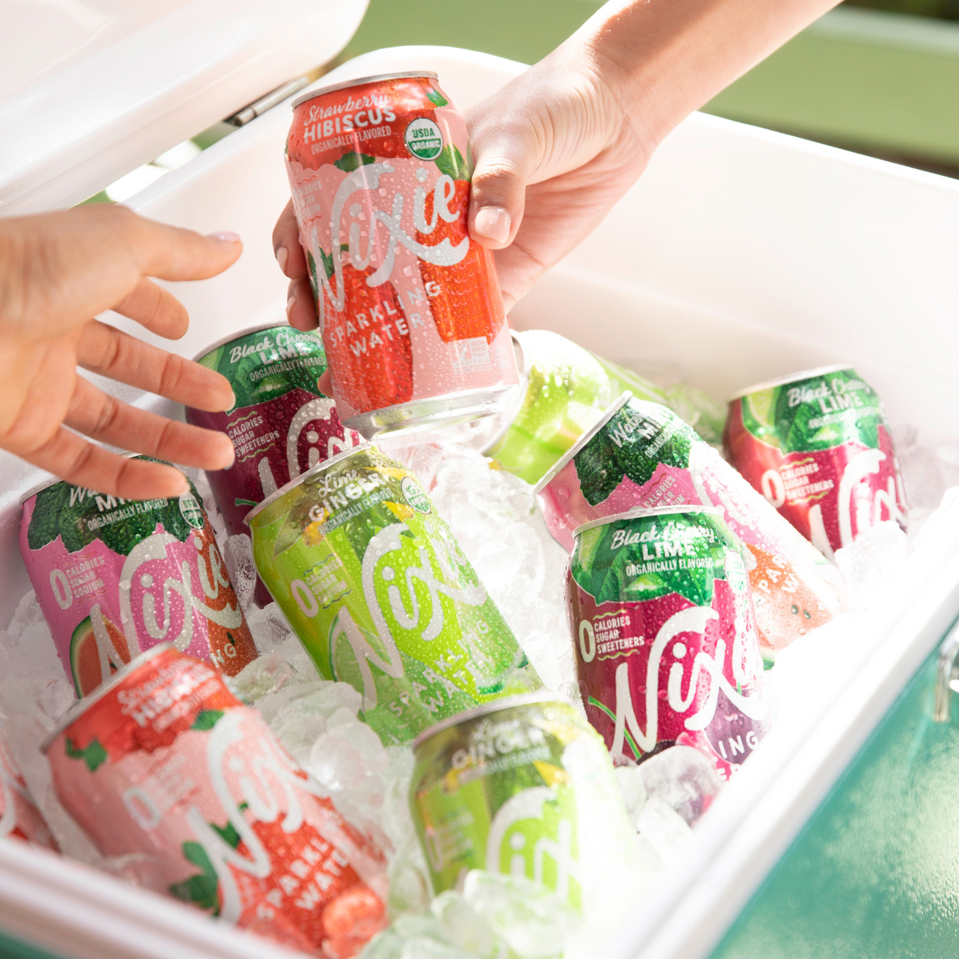cans of nixie in on ice in a cooler