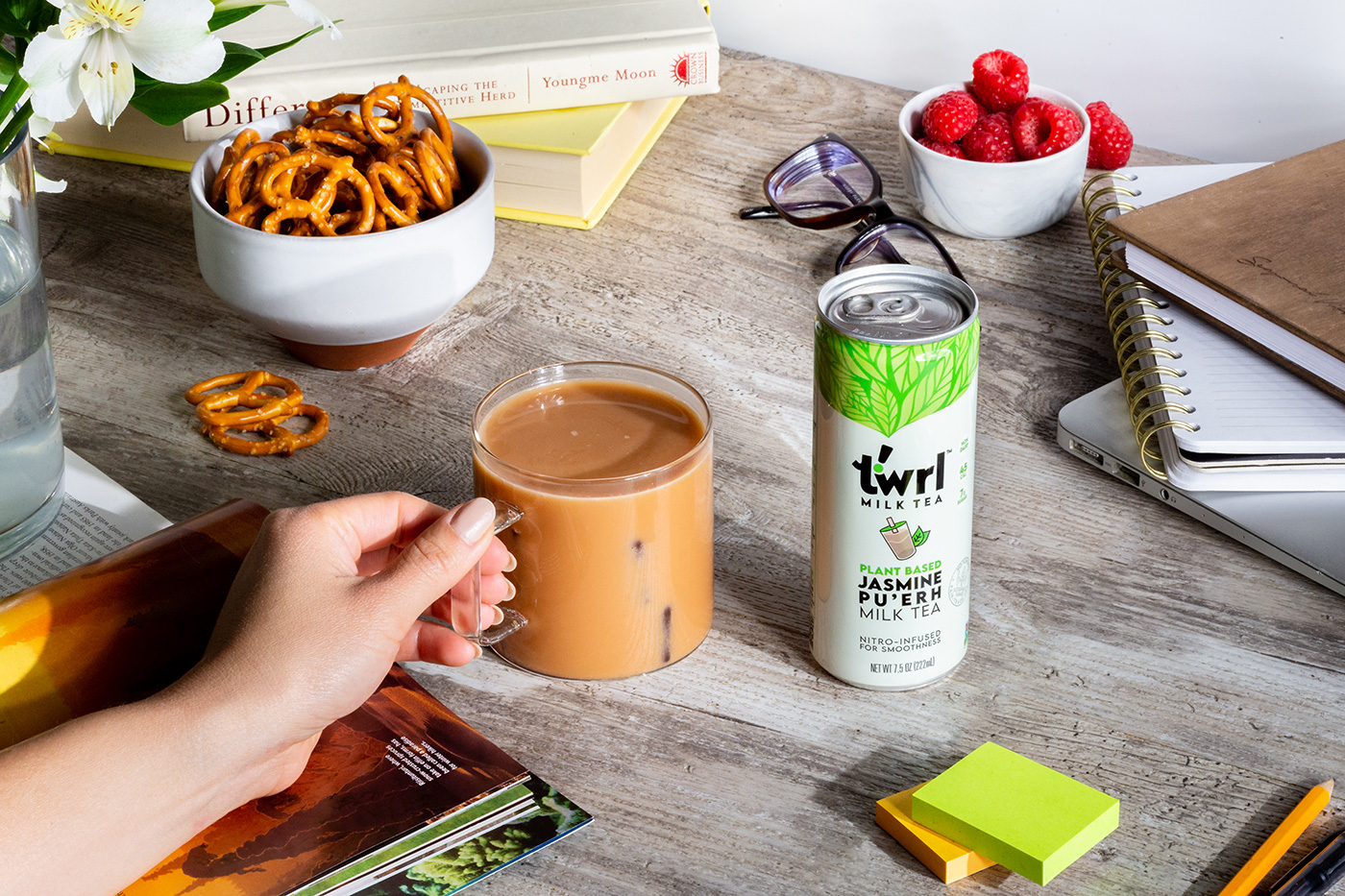Twrl in a glass mug next to pretzels