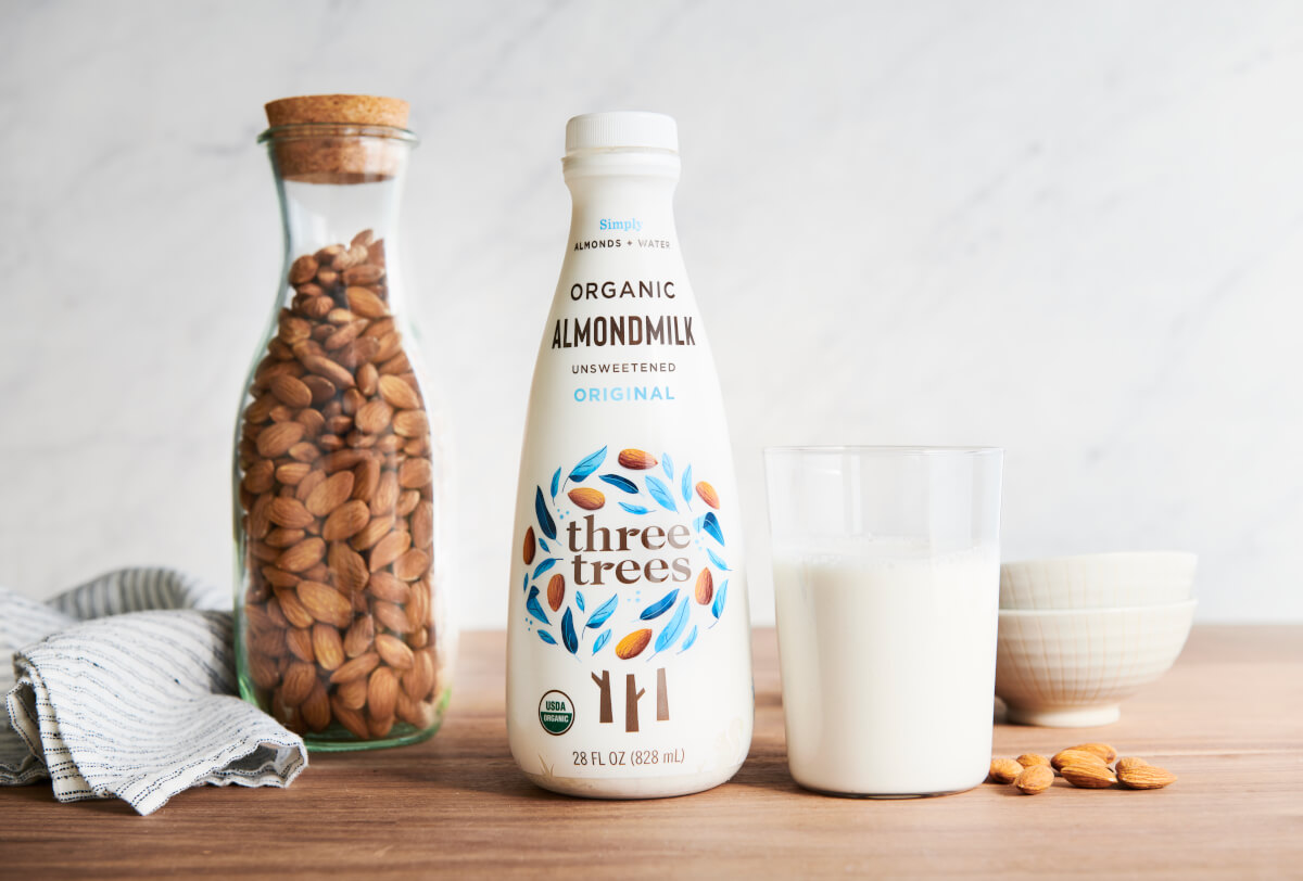 Bottle and glass of almond milk 