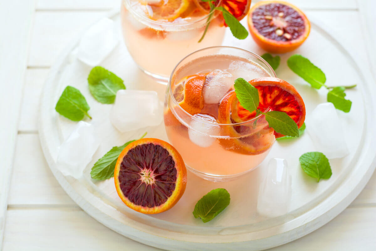 Blood orange cocktail with sliced blood oranges