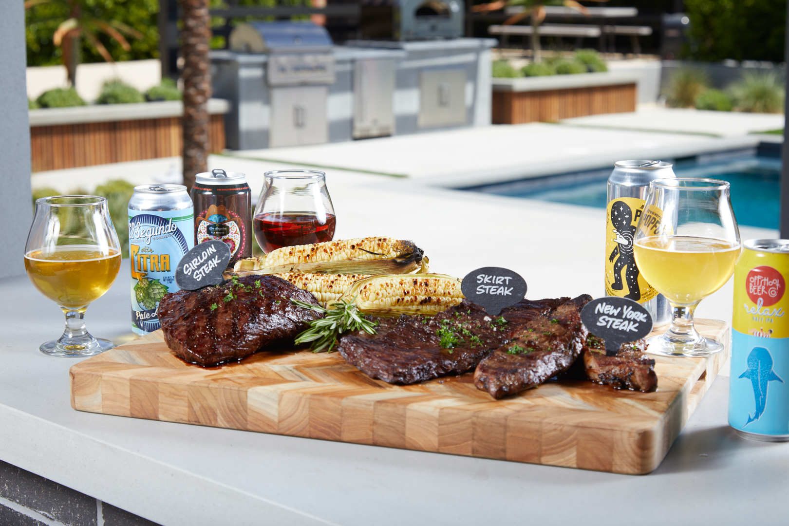 Steaks on a butcher block and beers