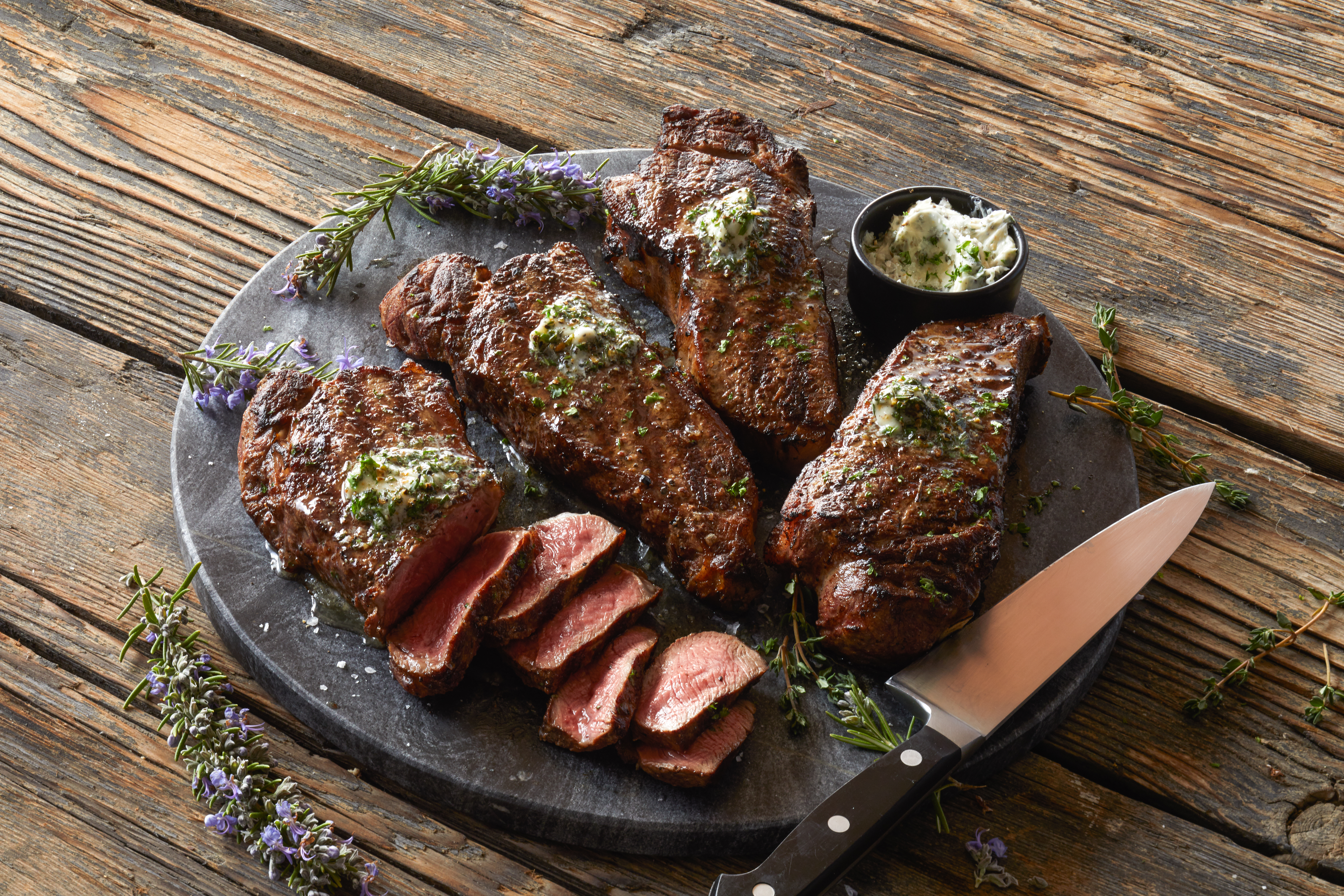 steaks in board with knife