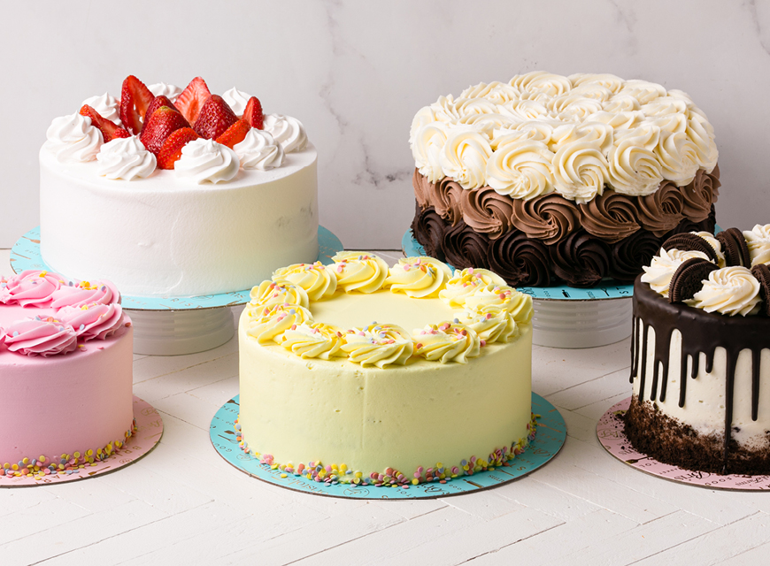 five cakes of different flavors, styles, and decoration