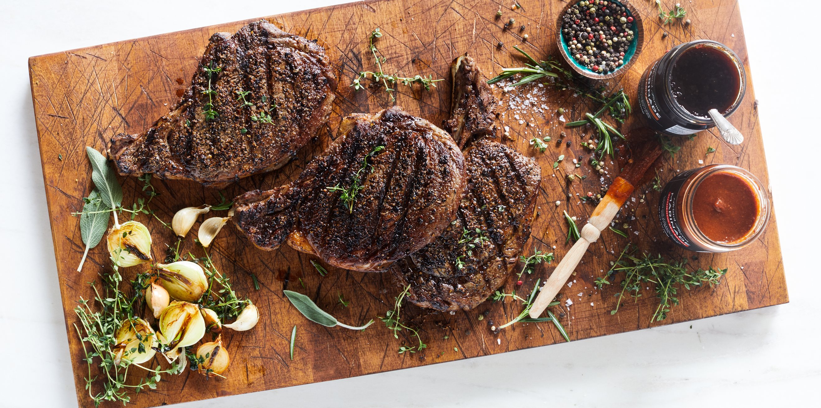 a rectangular white platter holding ribeye